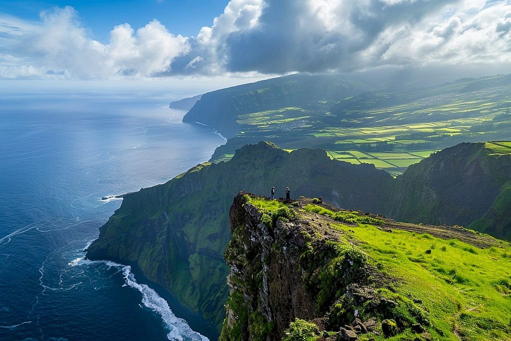 Family overlooking the Atlantic Ocean from a volcanic cliff on São Miguel Island during a slow travel Azores holiday with kids.