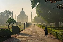 Family walking toward the Taj Mahal in Agra during early morning, illustrating Golden Triangle India with kids and family-friendly pacing at major heritage sites.