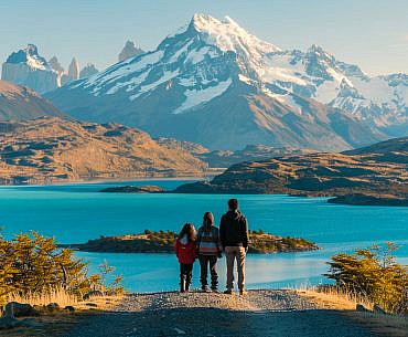 Family overlooking General Carrera Lake on the Carretera Austral in Chilean Patagonia during an outdoor adventure family road trip.