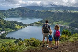 Family overlooking Sete Cidades lakes in the Azores, one of the best family adventure destinations for outdoor travel.
