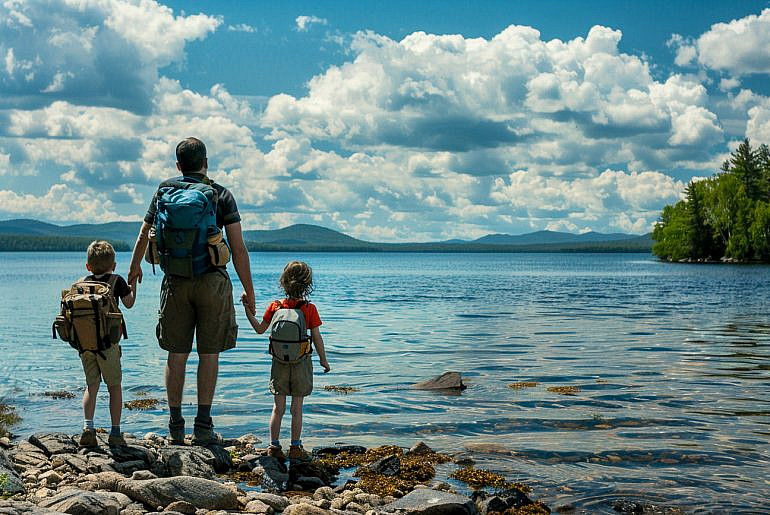 Family overlooking Rangeley Lake while exploring things to do in Rangeley Maine with kids.