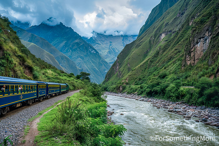 Train traveling through the Urubamba River valley from Ollantaytambo toward Aguas Calientes on a Machu Picchu with kids trip.