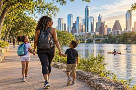 Family strolling along the waterfront during an Austin with kids outdoor adventure.