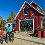 Family with two young boys and mountain bikes outside the Fort Ransom State Park Visitor Center in North Dakota’s Sheyenne River Valley during fall.